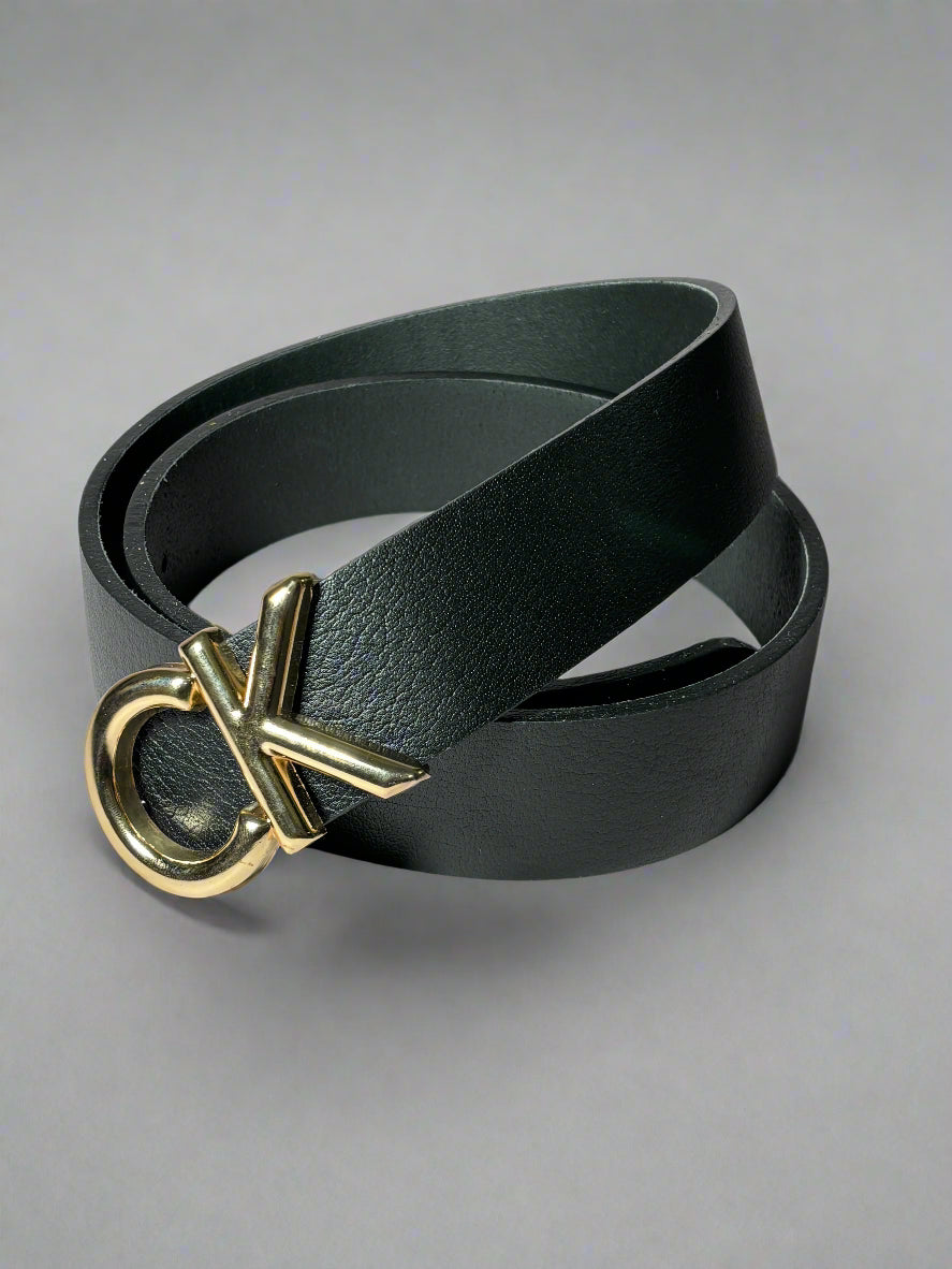 Black belt with gold logo buckle on a light gray background