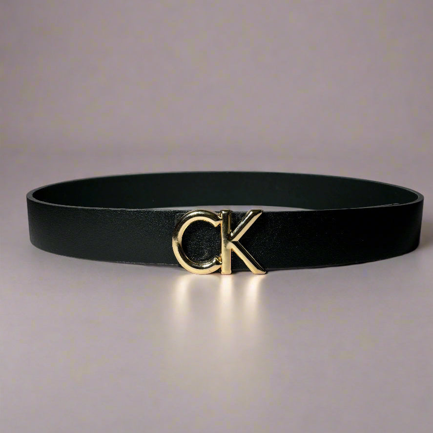 Black belt with gold logo on a light gray background