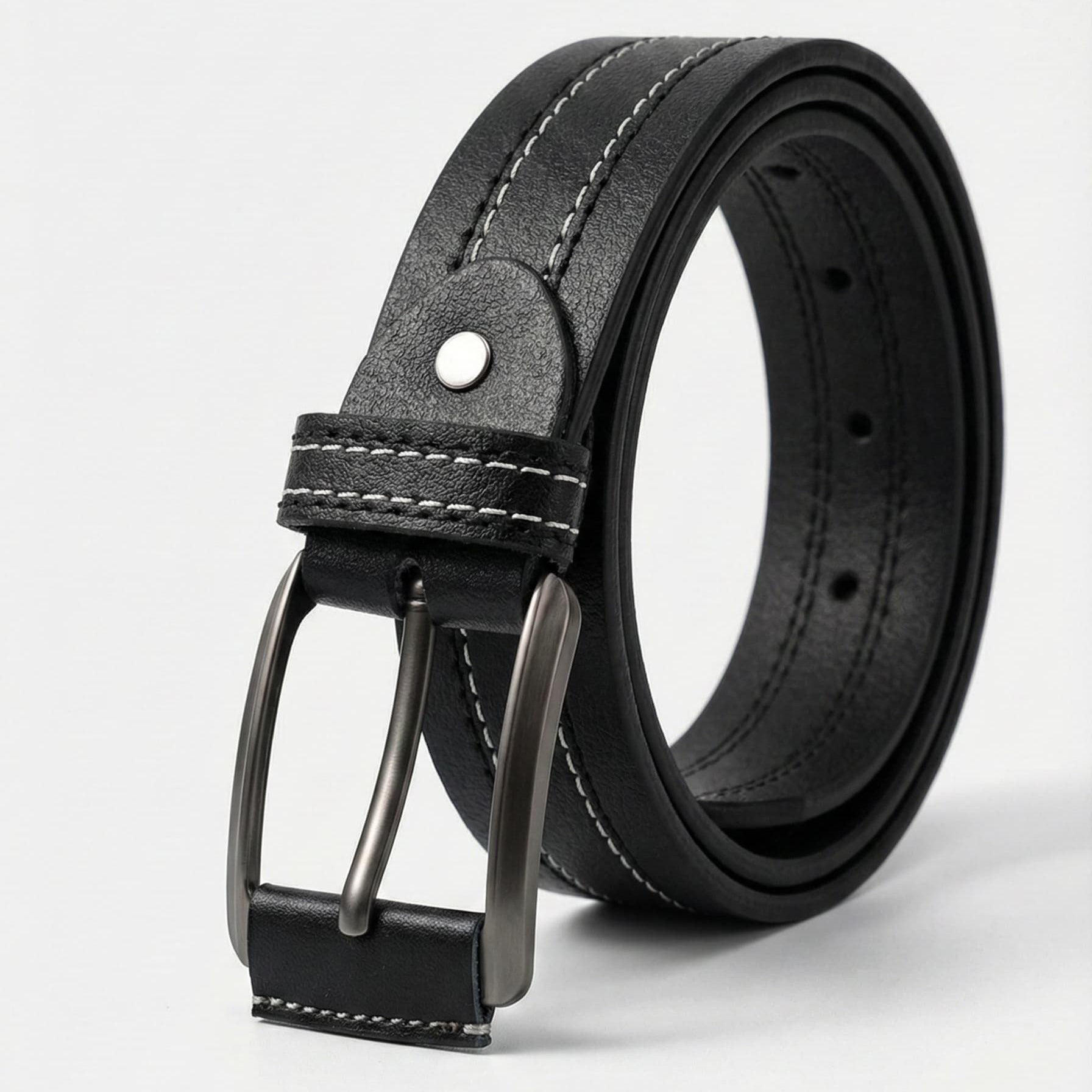 Black leather belt with a silver buckle on a light gray background