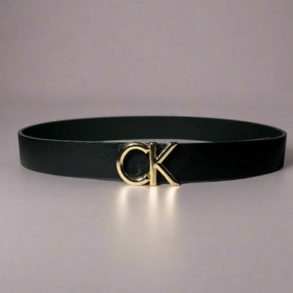 Black belt with gold logo on a light gray background