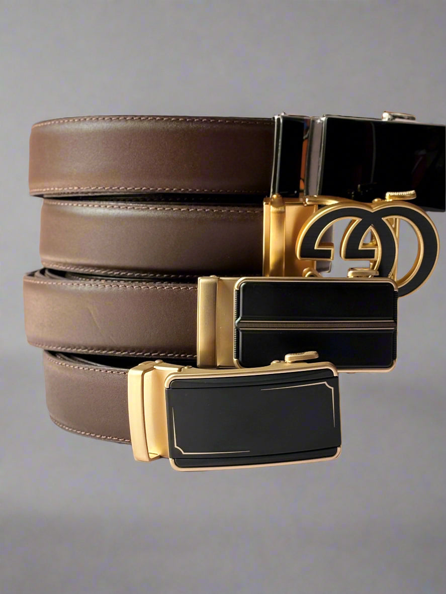Three belts with gold and black buckles on a light background