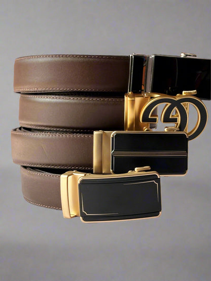 Three belts with gold and black buckles on a light background